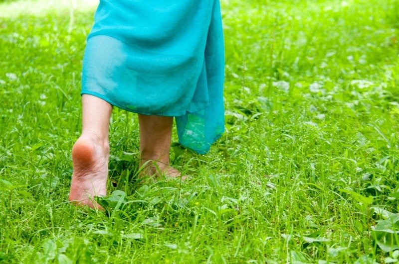 Barefoot walking on grass for natural Earthing and stress reduction